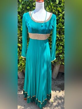 Teal Anarkali gown with intricate gold embroidery
